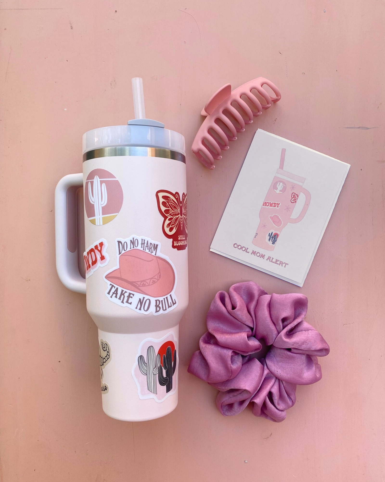 Stanley cup with stickers, scrunchie, hair clip, and cool mom alert greeting card